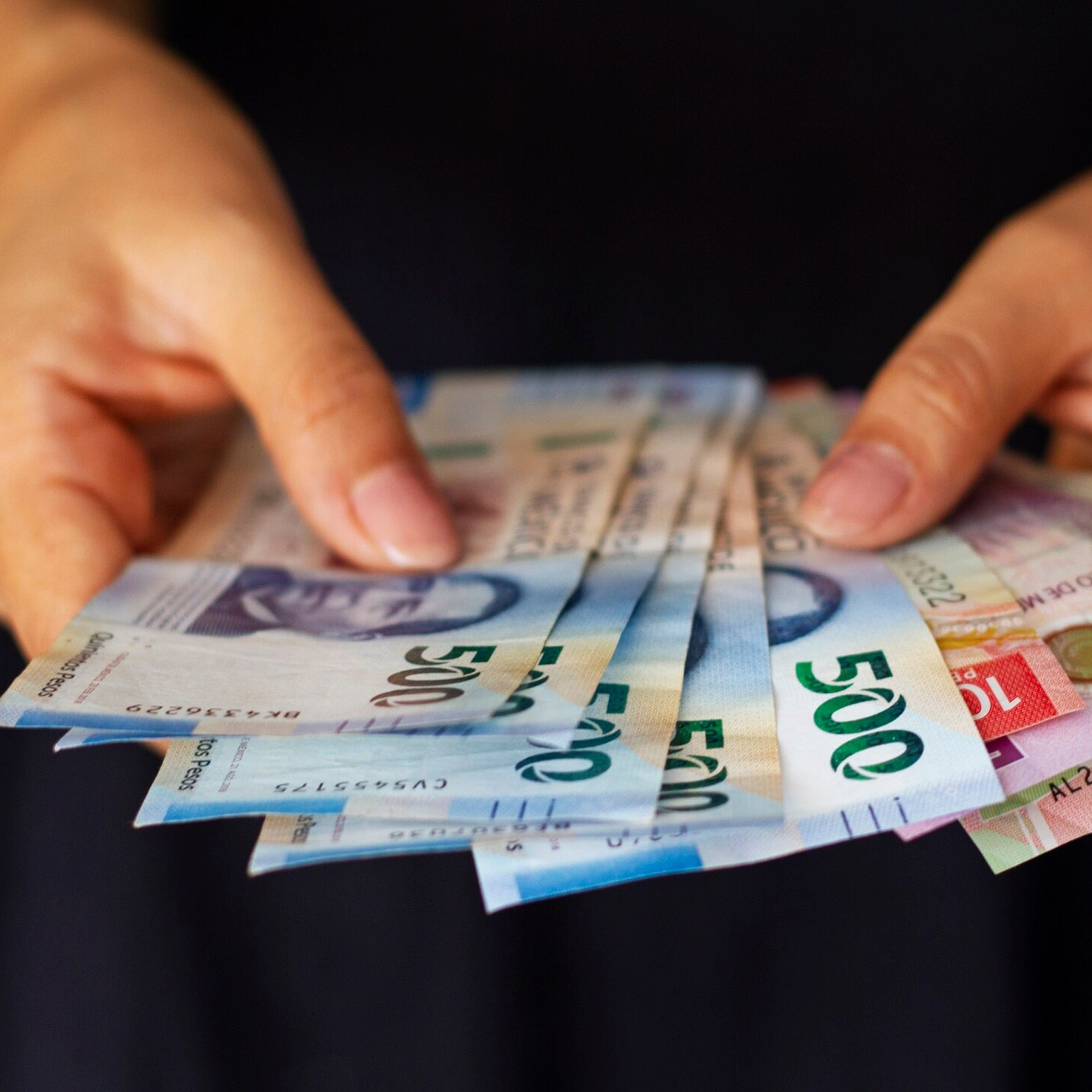Person Holding Foreign Currency